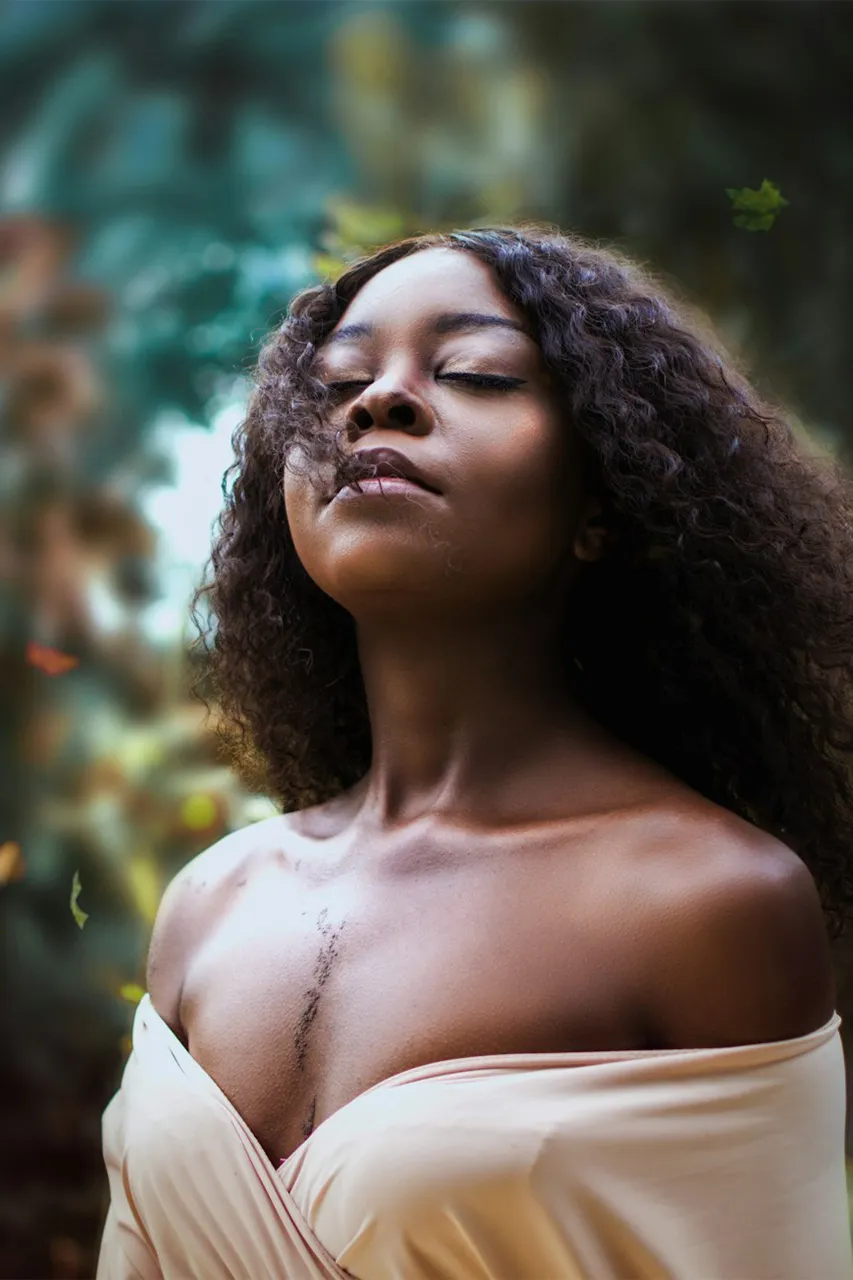 diana-simumpande-xZgkFQ4Hijc-unsplash-medium-2 a woman with curly hair and eyes closed