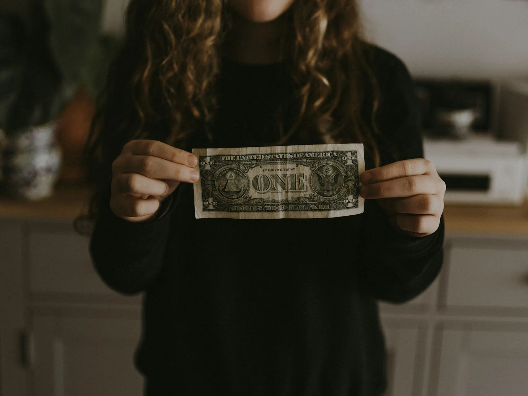 intuition_into_income Intuition into income woman holding dollar bill
