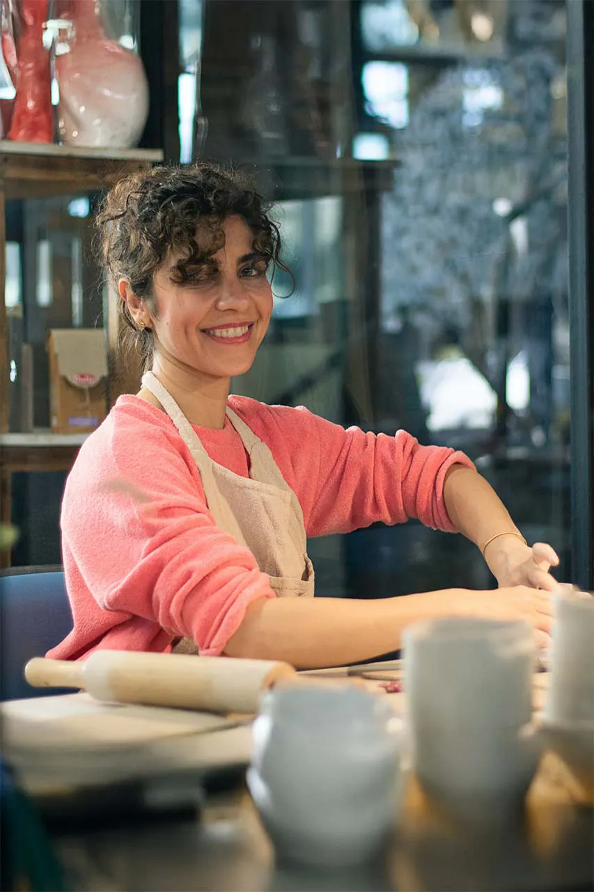 Woman happily working - you don't need to hustle for abundance