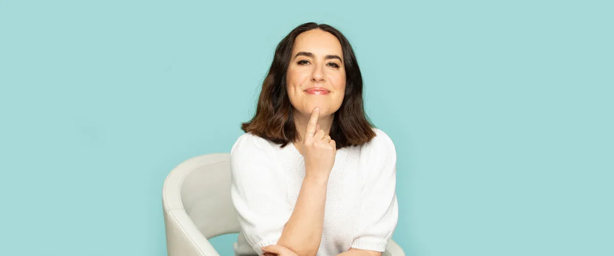 Heather Dominick mentor for highly sensitive entrepreneurs sitting on white chair